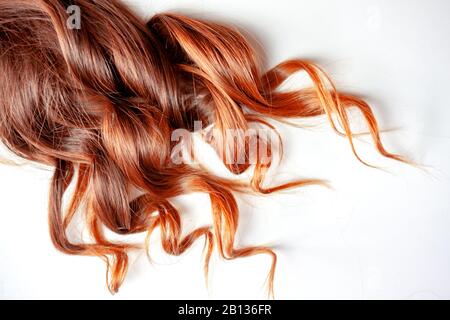 nice strawberry colored red curly hair on isolated white background Stock Photo