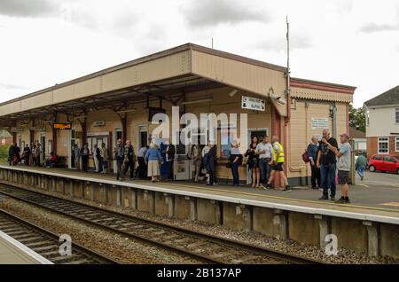 Warminster, UK - August 17, 2019: Passengers waiting for a train on a cloudy summer afternoon in Warminster, Wiltshire. Stock Photo