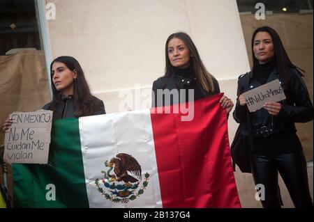 Women hold placards and a Mexican flag during a protest against gender -based violence in Mexico.Mexican women living in Spain participate in a protest against the feminicide of seven-year-old Fatima Cecilia Aldrighett in Mexico. They also claim justice and responsibility facing government of Manuel Lopez Obrador. Stock Photo