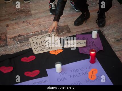 A woman places a note as she takes part in a protest against gender -based violence in Mexico.Mexican women living in Spain participate in a protest against the feminicide of seven-year-old Fatima Cecilia Aldrighett in Mexico. They also claim justice and responsibility facing government of Manuel Lopez Obrador. Stock Photo