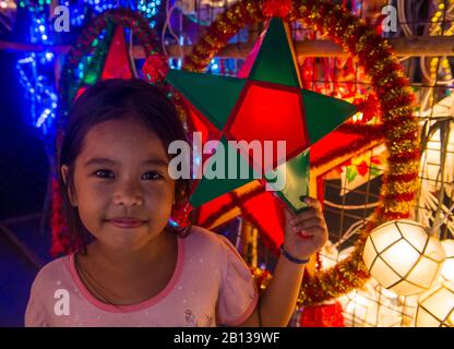 Filipino girl holding a lantern in a Christmas market in Las Pinas city , Manila the Philippines Stock Photo