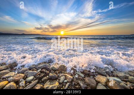 Waves of the Mediterranean sea breaking on pebble beach near Farinole Cap Corse, Corsica, France Stock Photo