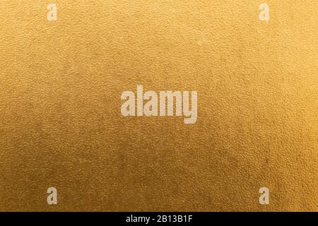 Shiny yellow gold foil texture background with gradient shadow. Stock Photo
