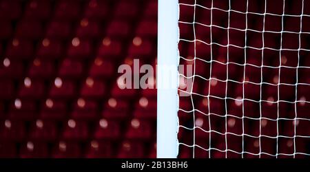 The soccer field view through white square gate net. Football sport background. Stock Photo