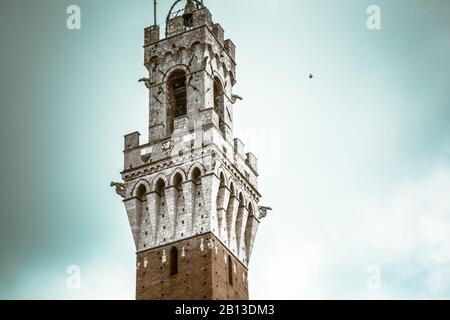 Detail of Clock Tower of Town hall in Siena, Italy / Public Palace on famous city square Piazza del Campo in Siena Stock Photo