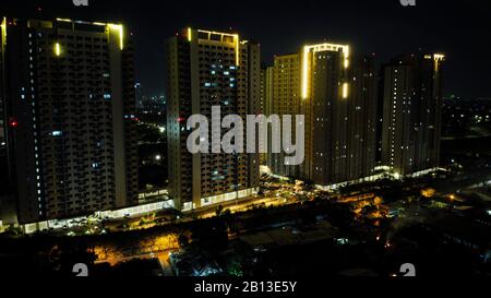 Bekasi, Indonesia, February 23 2020 : Aerial View or Drone Shot. Beautiful Residential area and apartment building in the Night Stock Photo