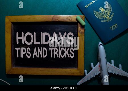Holidays Tips and Tricks write on a black board isolated on Office Desk Stock Photo