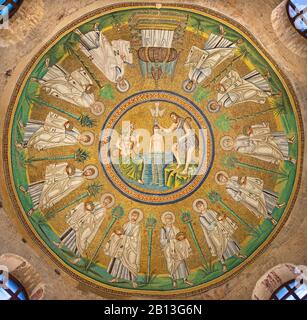 RAVENNA, ITALY - JANUARY 28, 2020: The ceiling symbolic mosaic with Baptism of Christ in the center among the apostles and saints in Arian baptistery. Stock Photo