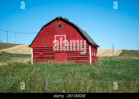 Old Red Barn on Grassy Farmland Prairie Stock Photo