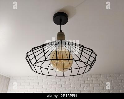 Loft ceiling hanging light pendant with retro style Edison lamp Stock Photo