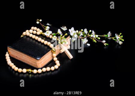 wooden rosary plum tree white flowers bible Stock Photo
