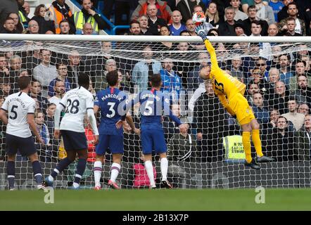 London, UK. 22nd Feb, 2020. Chelsea's goalkeeper Willy Caballero (1st R) jumps to save the ball during the Premier League London Derby match between Chelsea and Tottenham Hotspur at Stamford Bridge Stadium in London, Britain on Feb. 22, 2020. Credit: Han Yan/Xinhua/Alamy Live News Stock Photo