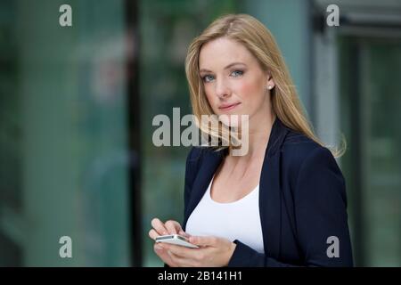 Young woman is using smartphone Stock Photo
