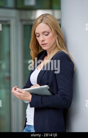 Young woman is using tablet PC, portrait Stock Photo