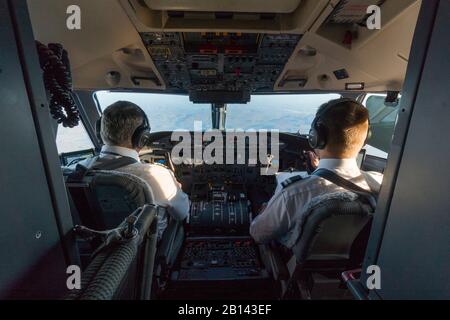 Two pilots in the cockpit of an airplane over Disko Bay, Greenland Stock Photo