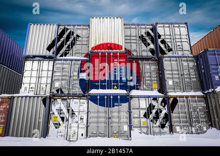The national flag of South Korea  on a large number of metal containers for storing goods stacked in rows on top of each other. Conception of storage Stock Photo