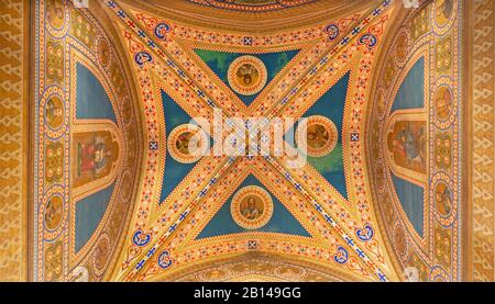 PARMA, ITALY - APRIL 16, 2018: The ceiling fresco with the Four evangelists from the ceiling of side chapel of Dome (cathedral) by Girolamo Magnani. Stock Photo