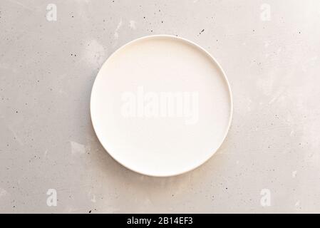Empty plate on grey wooden table. Stock Photo