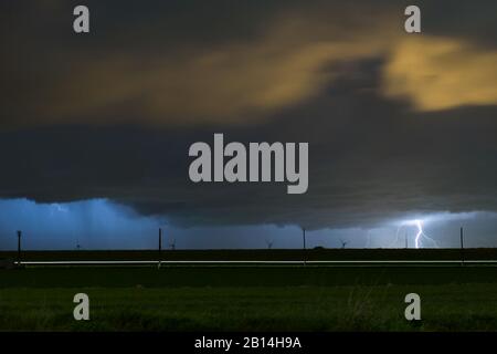 Storm with distant cloud to ground lightning strike at night Stock Photo