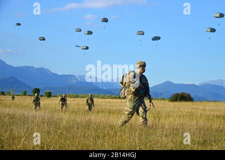 U.S. Army Paratroopers assigned to the Brigade Support Battalion, 173rd Airborne Brigade, move toward an objective after an airborne operation from an Air Force C-130 Hercules aircraft assigned to the 86th Air Wing at Juliet Drop Zone in Pordenone, Italy Sept. 21, 2017. The 173rd Airborne Brigade is the U.S. Army Contingency Response Force in Europe, capable of projecting ready forces anywhere in the U.S. European, Africa or Central Commands' areas of responsibility. (U.S. Army photos by Paolo Bovo)