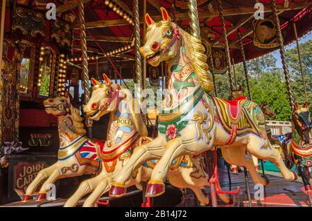 Basingstoke, UK - September 1, 2019: Colourful painted wooden horses on the vintage steam galloper ride at the vintage Carter's Steam Fair, Basingstok Stock Photo