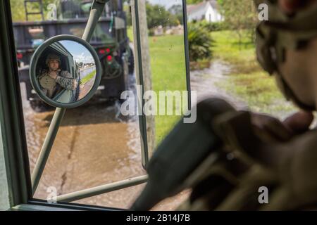 U.S. Marine Corps Cpl. KC Arellano, diesel mechanic with Detachment Bravo, Marine Wing Support Squadron 473, Marine Air Craft Group 41, 4th Marine Aircraft Wing, Marine Forces Reserve, looks out of a 7-ton truck at the flooded streets of Orange, Texas, Sept. 3, 2017. Hurricane Harvey landed in eastern Texas on Aug. 25, 2017, flooding thousands of homes and displacing over 30,000 people. (U.S. Marine Corps photo by Lance Cpl. Niles Lee)
