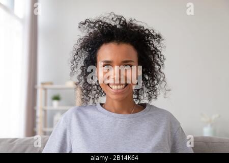 Happy african woman looking at camera making videocall recording vlog Stock Photo