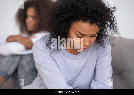 Upset african mom of teen daughter feeling sad after fight Stock Photo