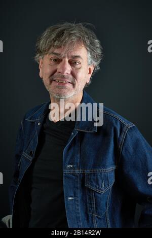 Portrait of a man with in blue denim jacket on gradient background Stock Photo