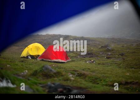 A lightweight hiking dome tent and a geodesic tent. Stock Photo