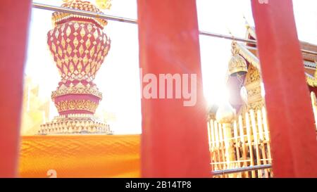 Golden Buddhist bell for prayer wishes in sunlight at Wat Phra That Doi Suthep temple, Chiang Mai, Thailand. Wat Phra That Doi Suthep is popular famou Stock Photo