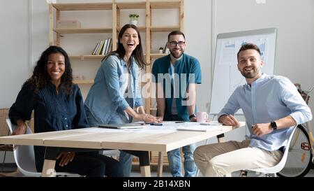 Portrait of excited young multiracial teammates in office. Stock Photo