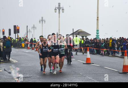 Brighton UK 23rd February 2020 - The early pace setters as thousands take part in The Grand Brighton Half Marathon in wet and windy weather conditions . Over ten thousand runners took part and this years official charity partners is The Sussex Beacon which provides specialist care and support for people living with HIV  : Credit Simon Dack / Alamy Live News Stock Photo