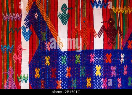 Detail of a traditional Mayan Guatemalan woven colorful striped fabric with horse and bird embroidery Stock Photo