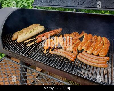 grill meat, barbecue sausages and baguettes on a grill, Germany Stock Photo