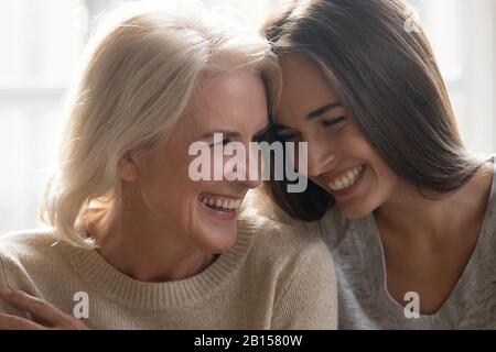 Head shot close up portrait happy mature mother and daughter. Stock Photo