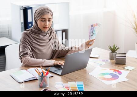 Arabic female graphic designer working on new project in office Stock Photo