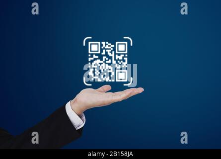 Hand holding QR code on hand. QR code scanning payment and verification technology Stock Photo
