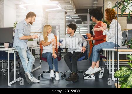 Happy young team enjoying time together, having break Stock Photo