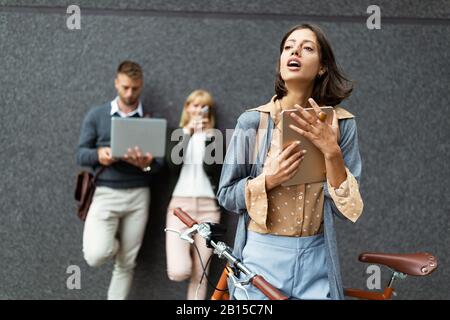 Young business people outdoors working, brainstorming. Technology concept Stock Photo