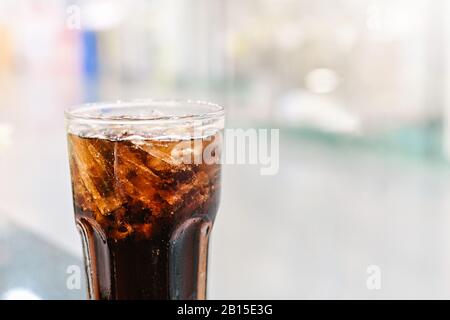 Cola soft drink with Ice ,Cola Glass close-up on abstract blurred restaurang backgrounds Stock Photo