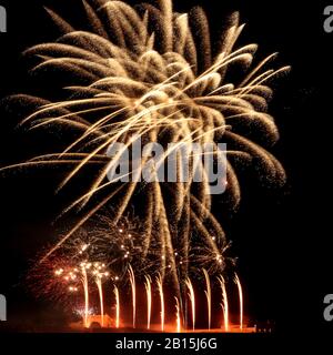 Variety of fireworks going off at the same time against a black sky at an event in Koblenz, Germany. Stock Photo