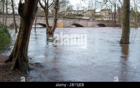 Flooded riverside path on the River Wharfe with high water levels flowing under Thorp Arch bridge at Boston Spa following Storm Dennis Stock Photo