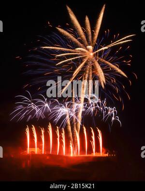 Gold and blue fireworks at the top with white in the middle and red on the bottom against a black sky. Display over the Ehrenbreitstein Fortress at an Stock Photo