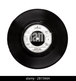 Old original Phonogram Ltd vinyl 45 RPM record Do They Know It's Christmas by Band Aid 1984 isolated on white. Geldof and Ure Stock Photo