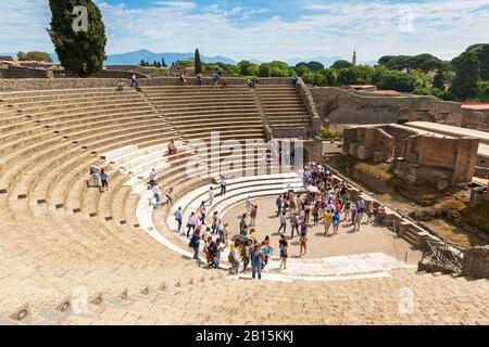POMPEII, ITALY - MAY 13: Tourists visit the ruins of the amphitheater. Pompeii is an ancient Roman city died from the eruption of Mount Vesuvius in 79 Stock Photo