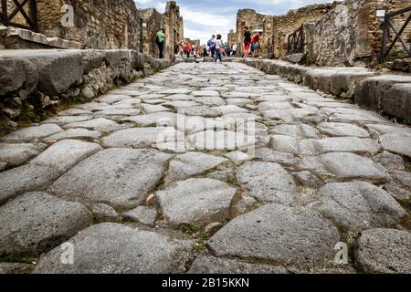 POMPEII, ITALY - MAY 13, 2014: The ancient street. Pompeii is an ancient Roman city died from the eruption of Mount Vesuvius in 79 AD. Stock Photo