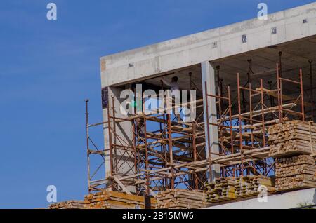 Builders work on the construction of a building in Glyfada Athens Attica Greece Stock Photo