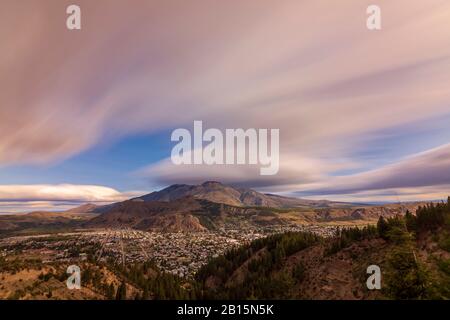 Cityscape view of Esquel city  in the valley surrounded by mountains on a windy day Stock Photo