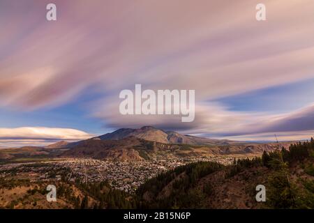 Cityscape view of Esquel city  in the valley surrounded by mountains on a windy day Stock Photo